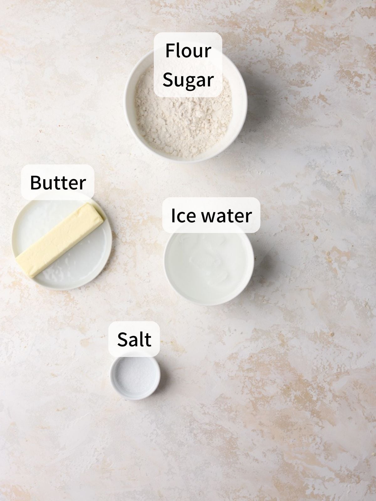 Ingredients needed to make pie crust laid out on a table. 