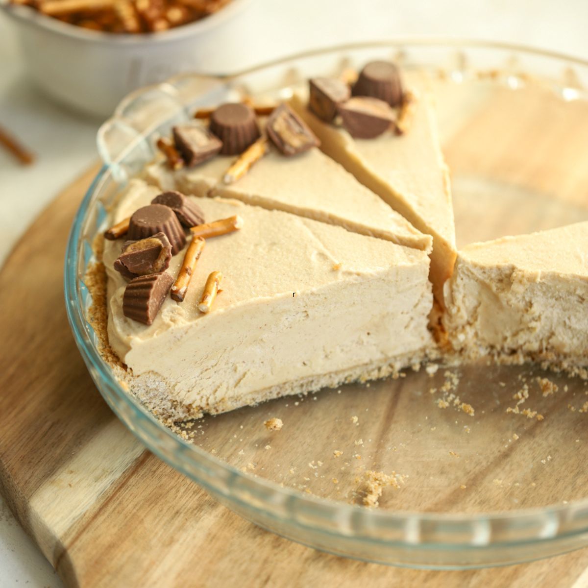Peanut butter pretzel pie sliced in a pie dish.