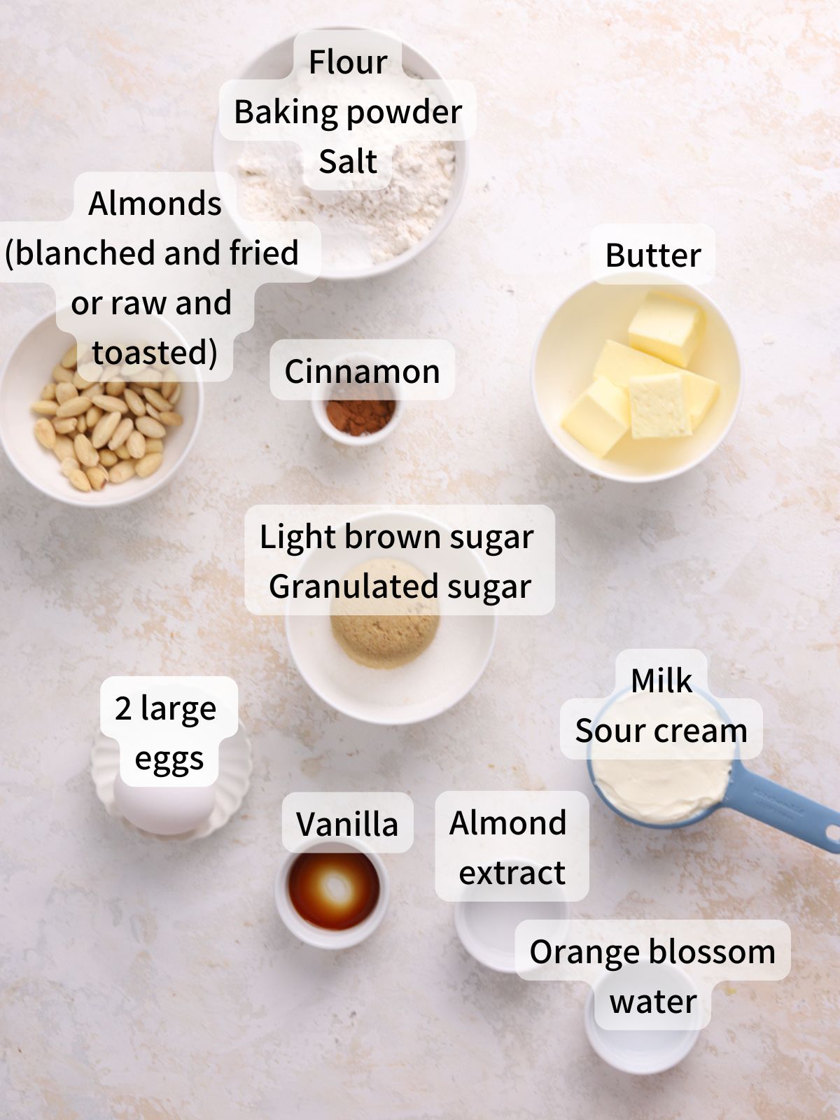 Labeled ingredients needed to make almond coffee cake laid out on a table.