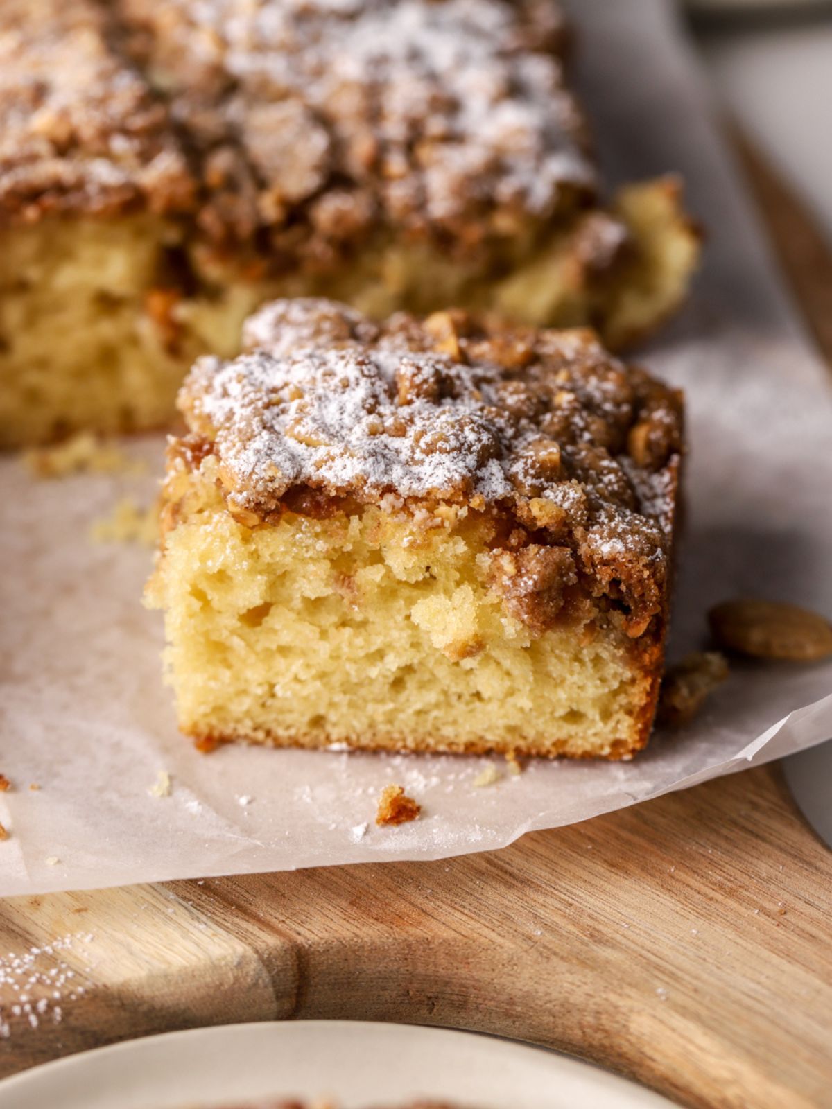 A piece of almond cake topped with powdered sugar.