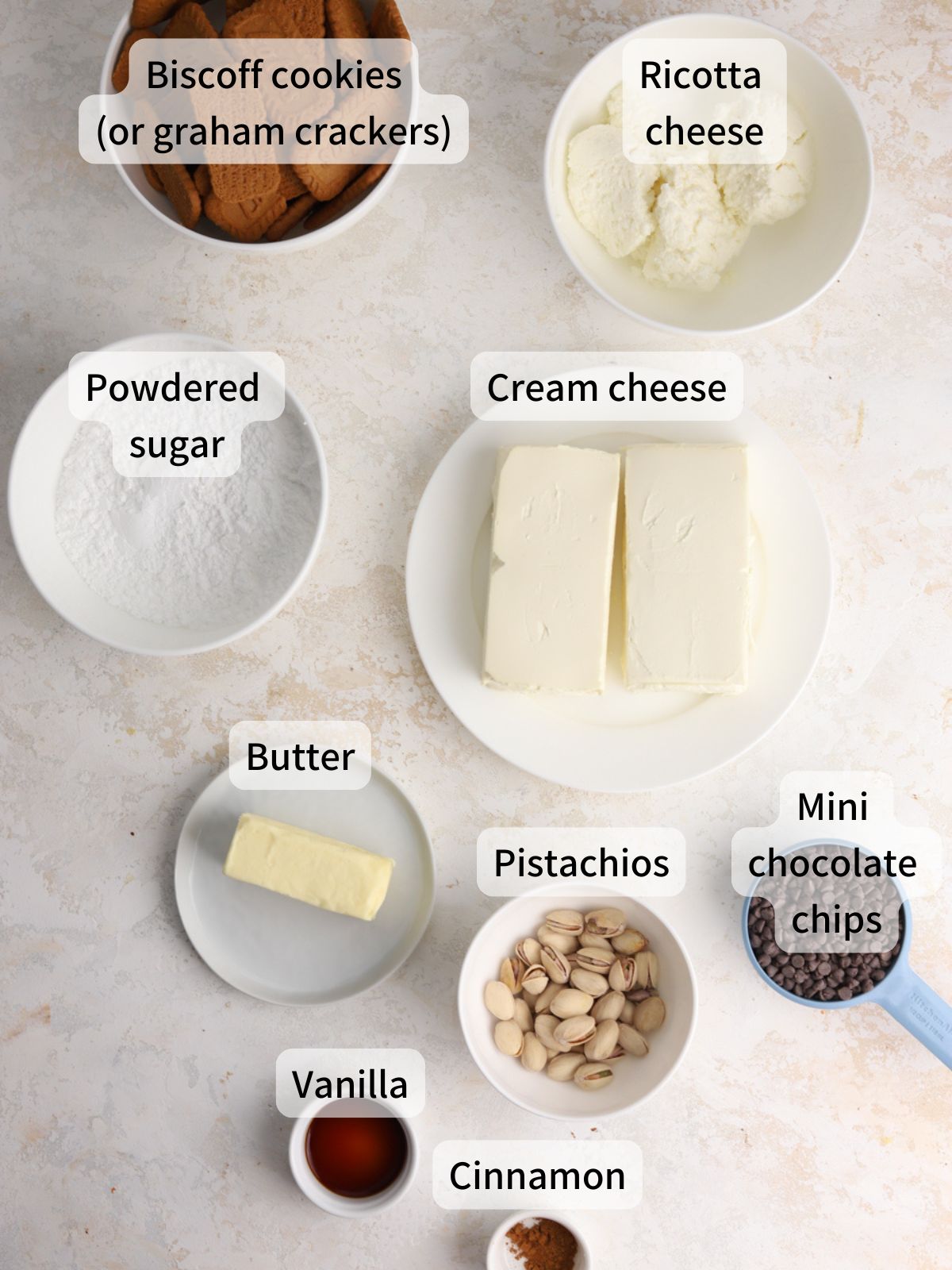Labeled ingredients needed to make cannoli bars laid out on a table. 