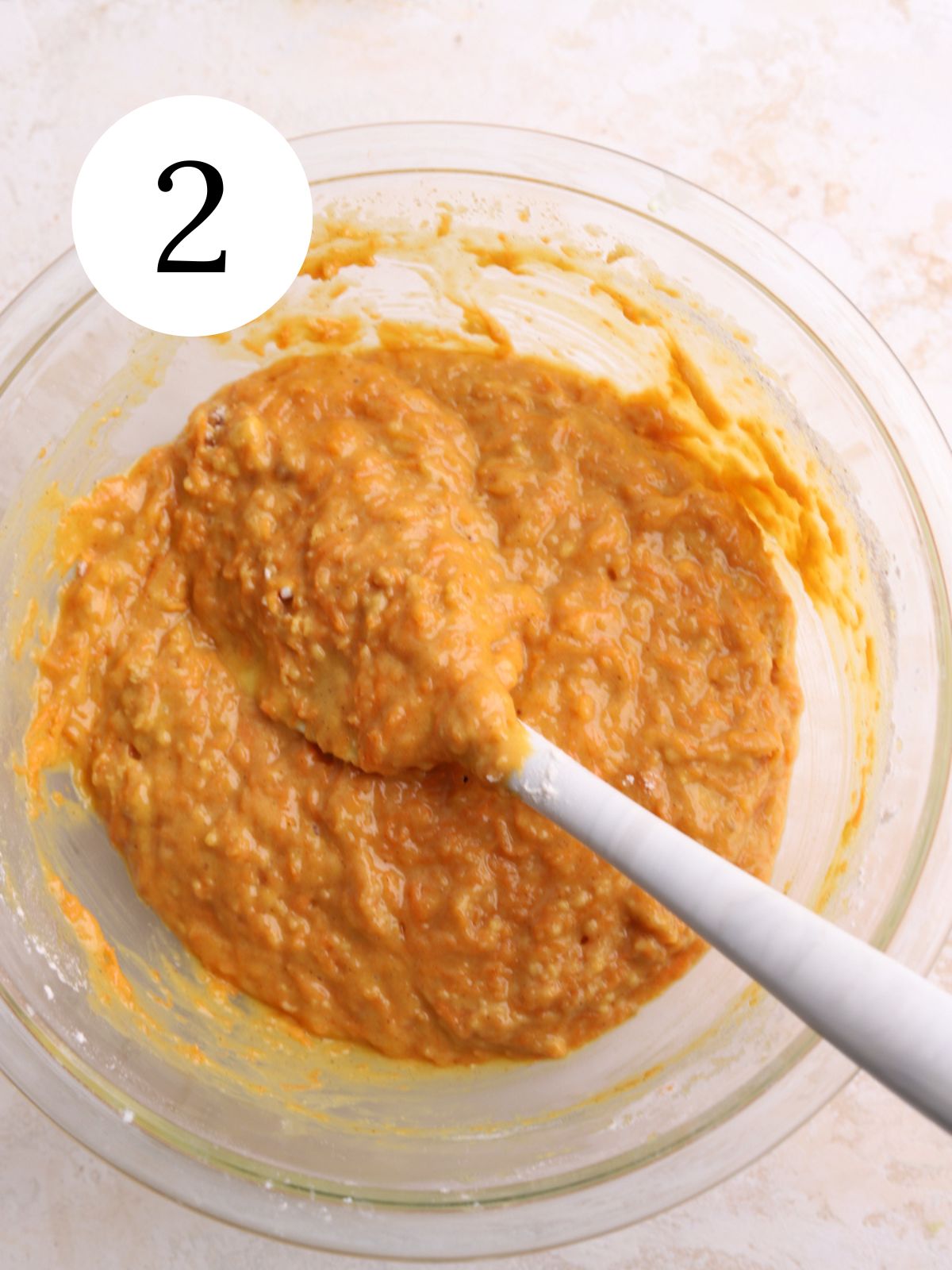 Carrot cake batter stirred together with a spatula.