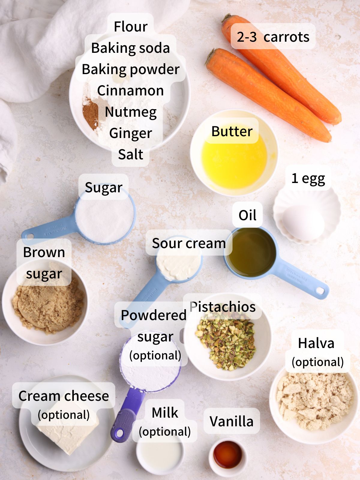 Labeled ingredients needed to make carrot coffee cake laid out on a table. 