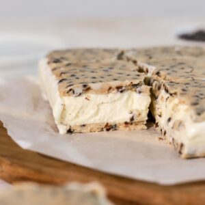 Cookie dough ice cream sandwiches on parchment paper.