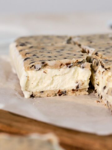 Cookie dough ice cream sandwiches on parchment paper.