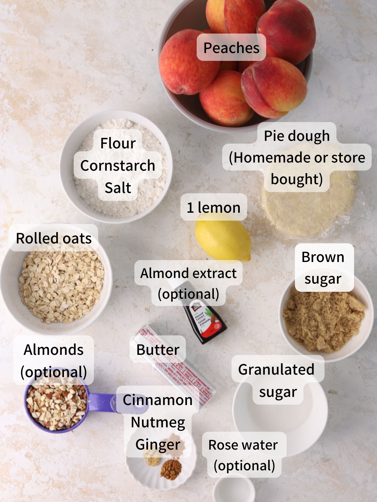 Labeled ingredients needed to make peach crumble pie laid out on a table. 