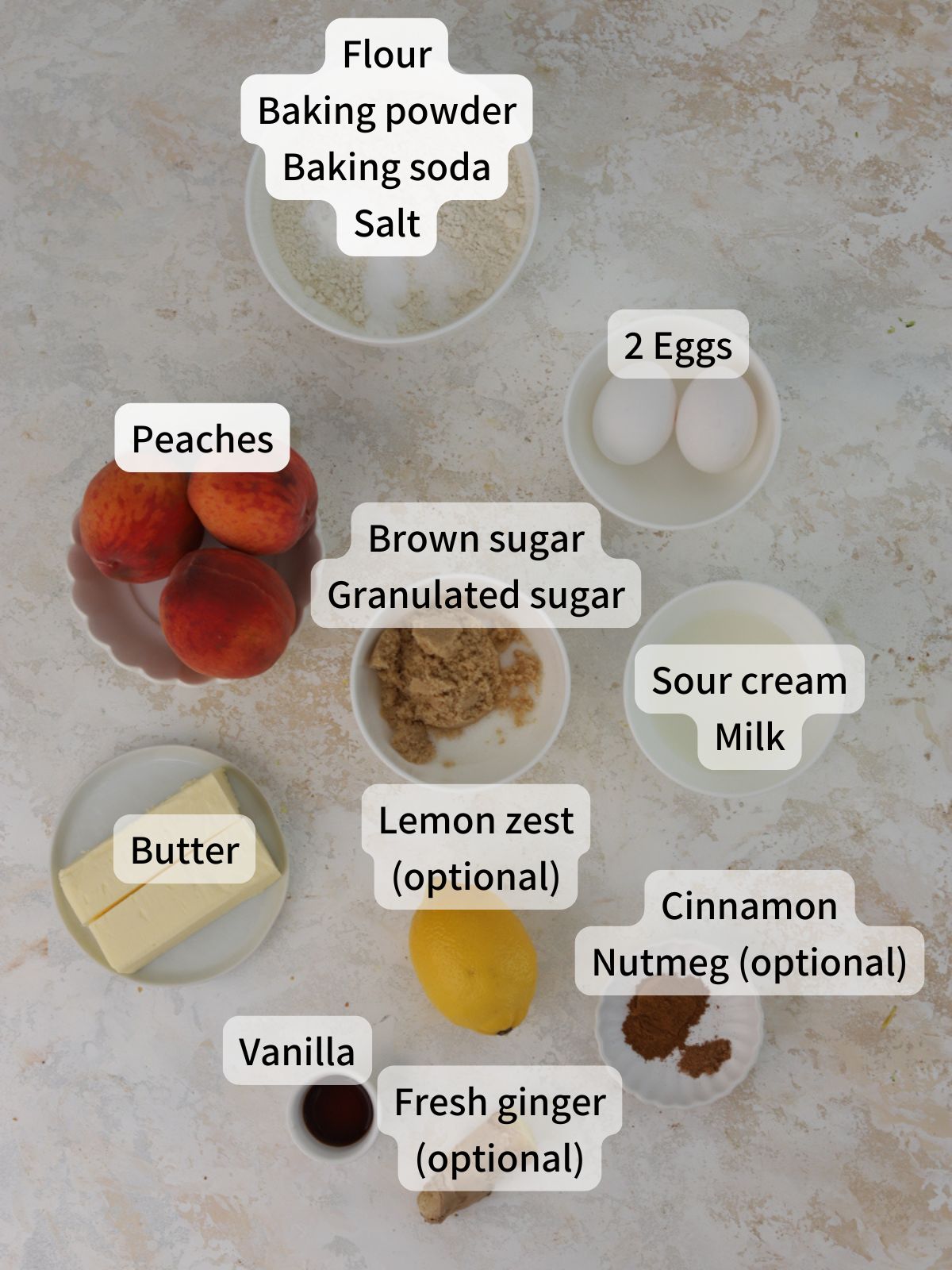 Labeled ingredients needed to make peach muffins laid out on a table. 