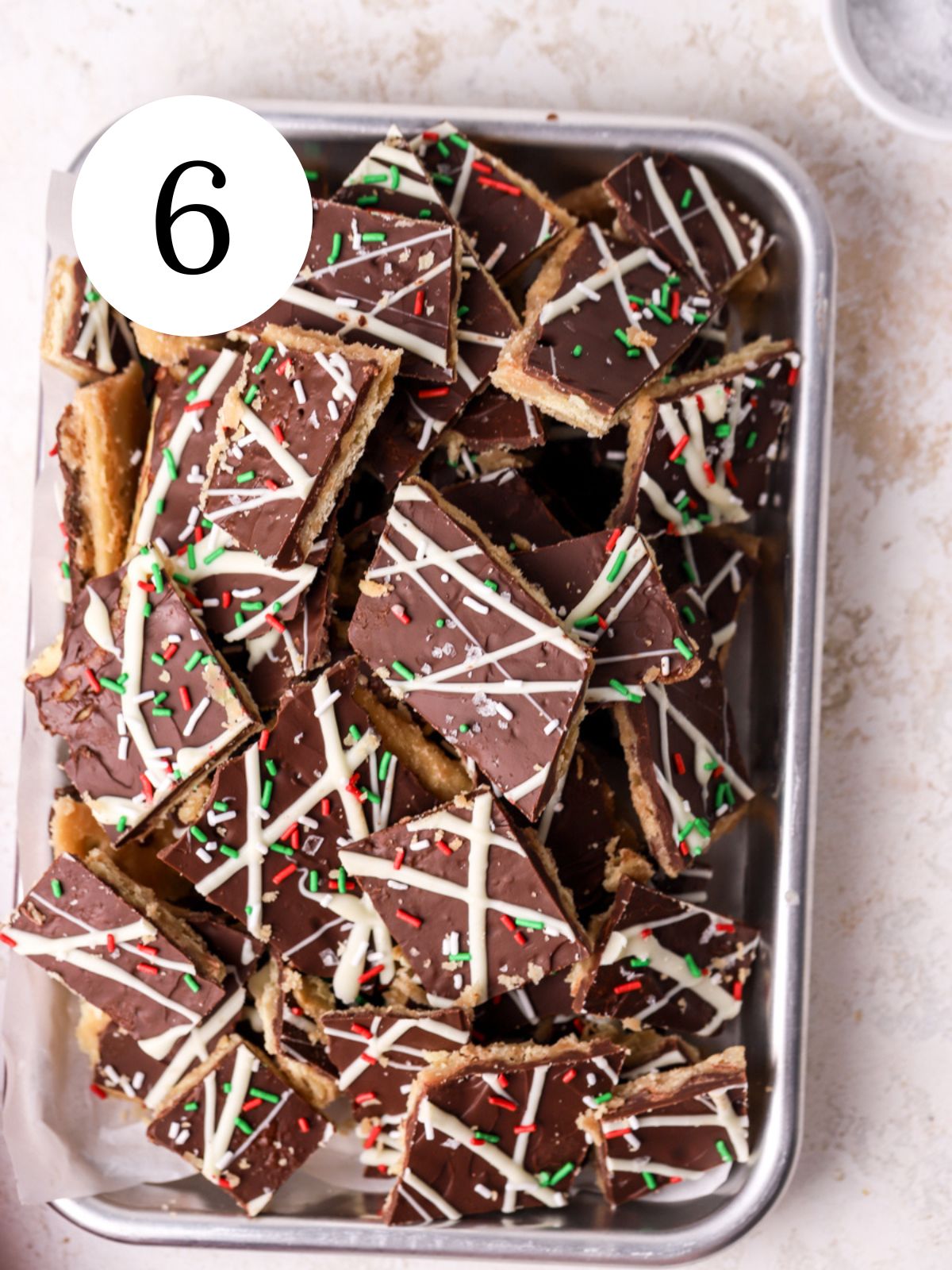 Christmas crack cut into squares and piled into a small baking sheet.