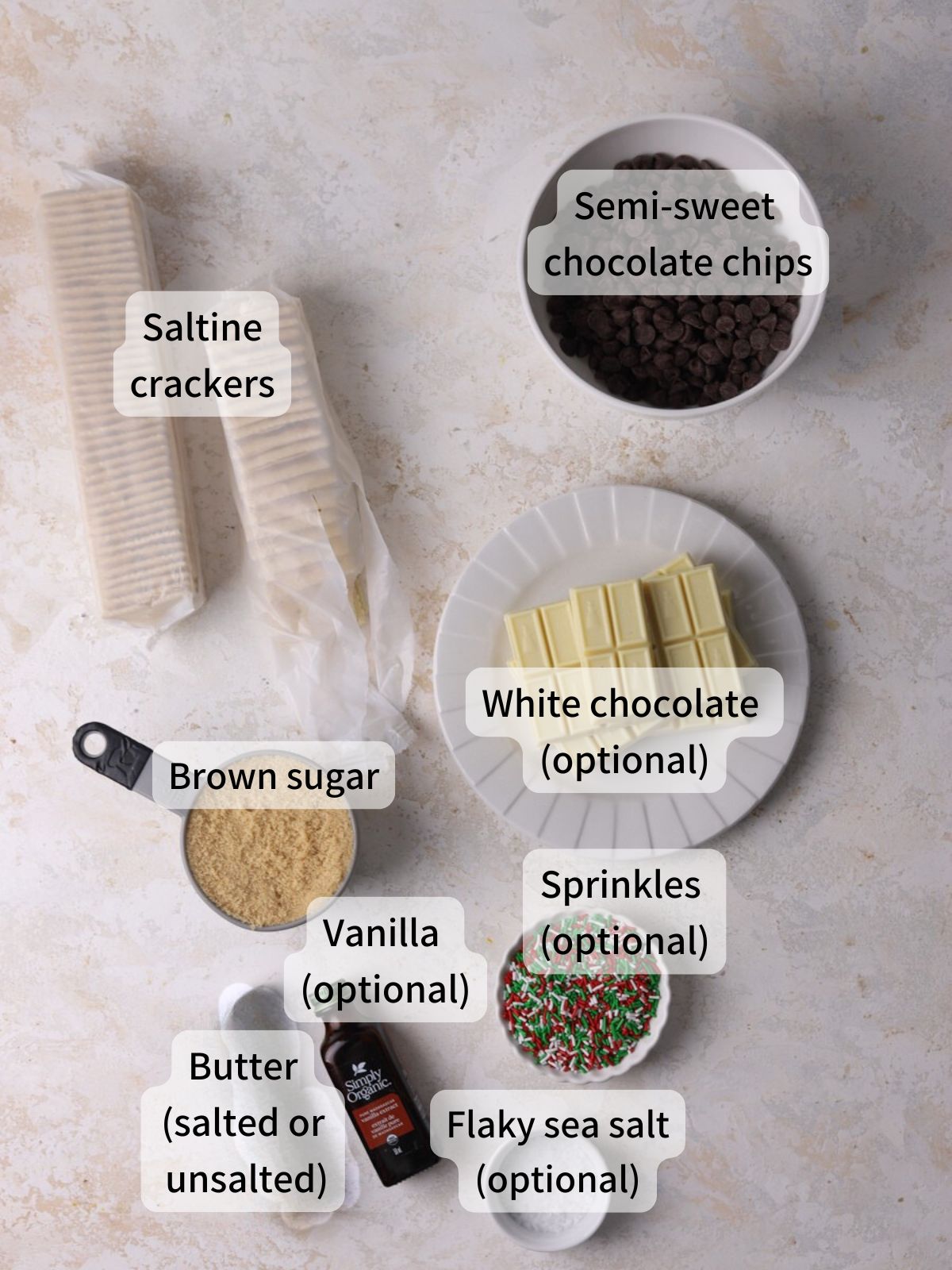 Labeled ingredients needed to make christmas crack laid out on a table. 
