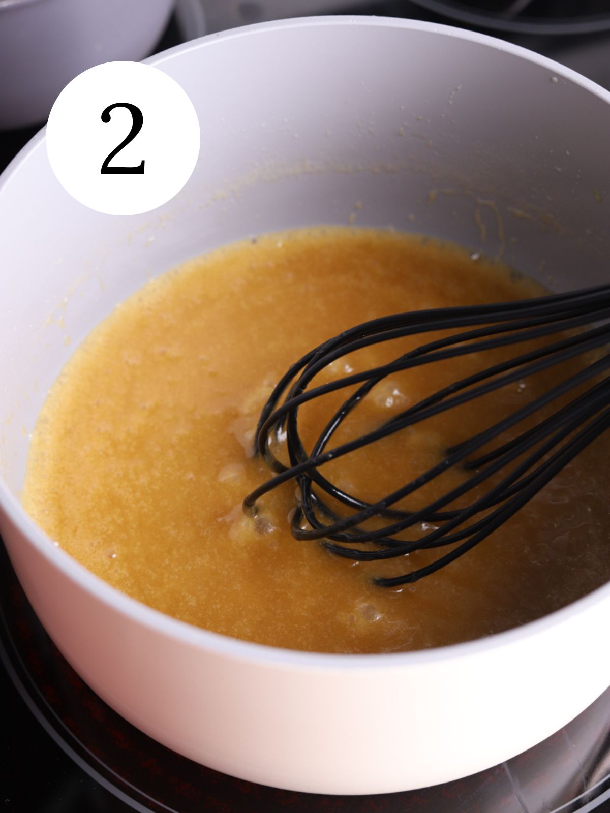 Toffee being whisked in a saucepan.