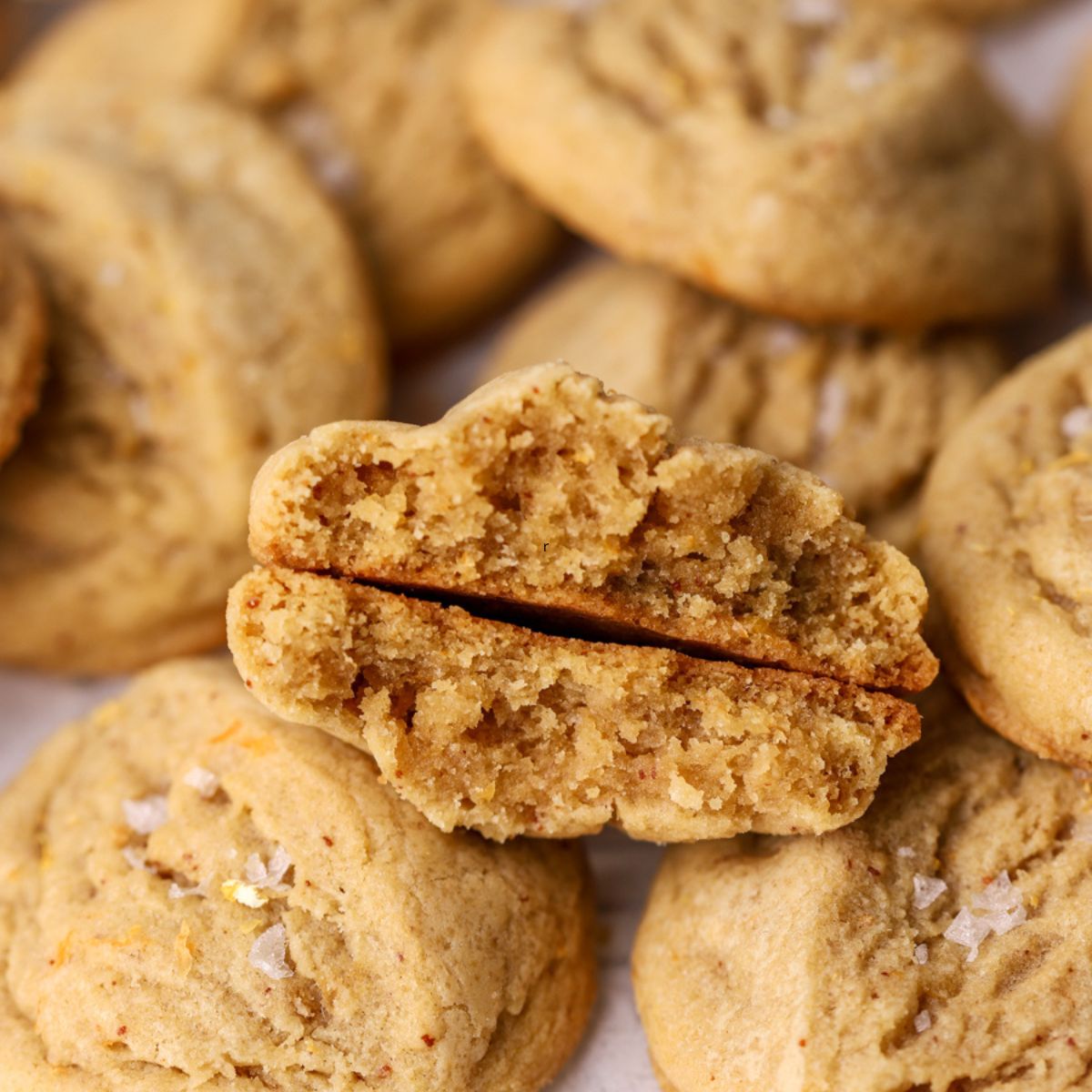 A batch of grapefruit cookies and one split in half.