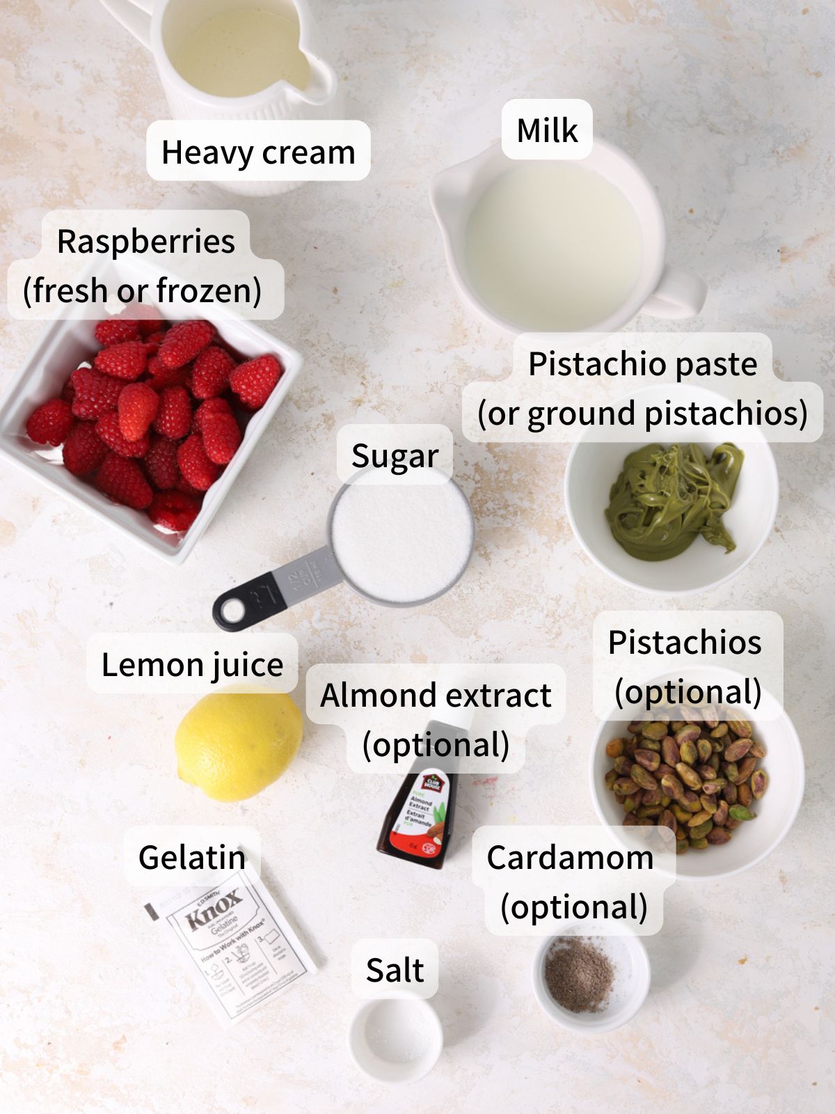Labeled ingredients needed to make pistachio panna cotta laid out on a table.