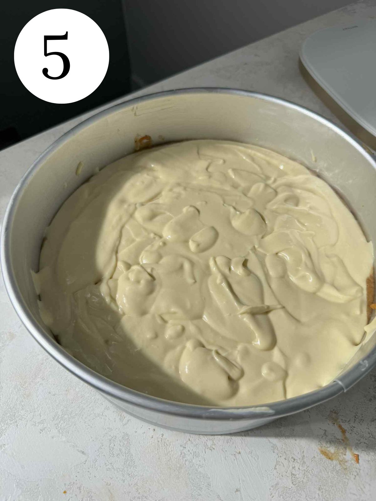 Cheesecake batter in a springform pan.
