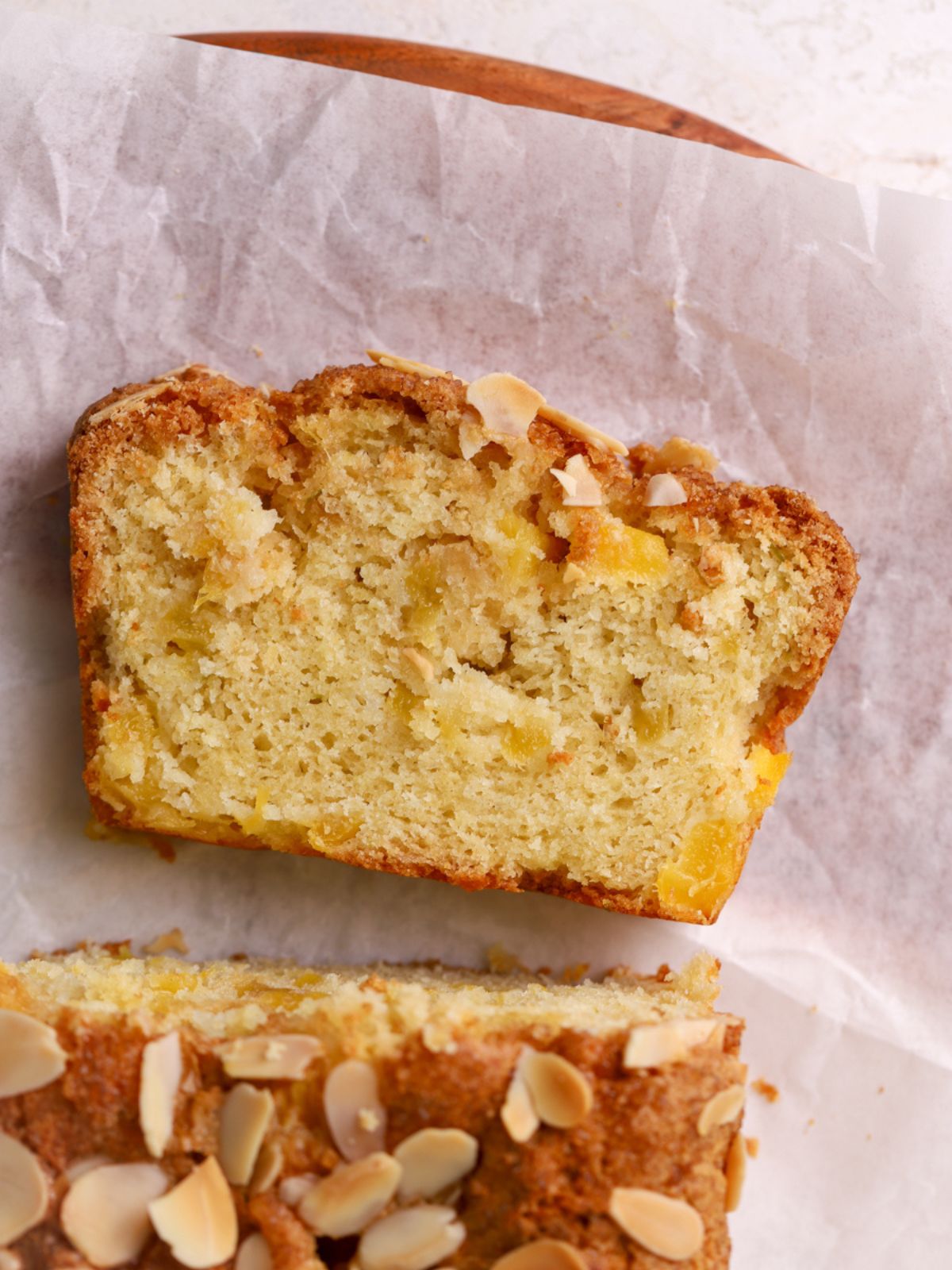 A slice of loaf cake with bits of mango.