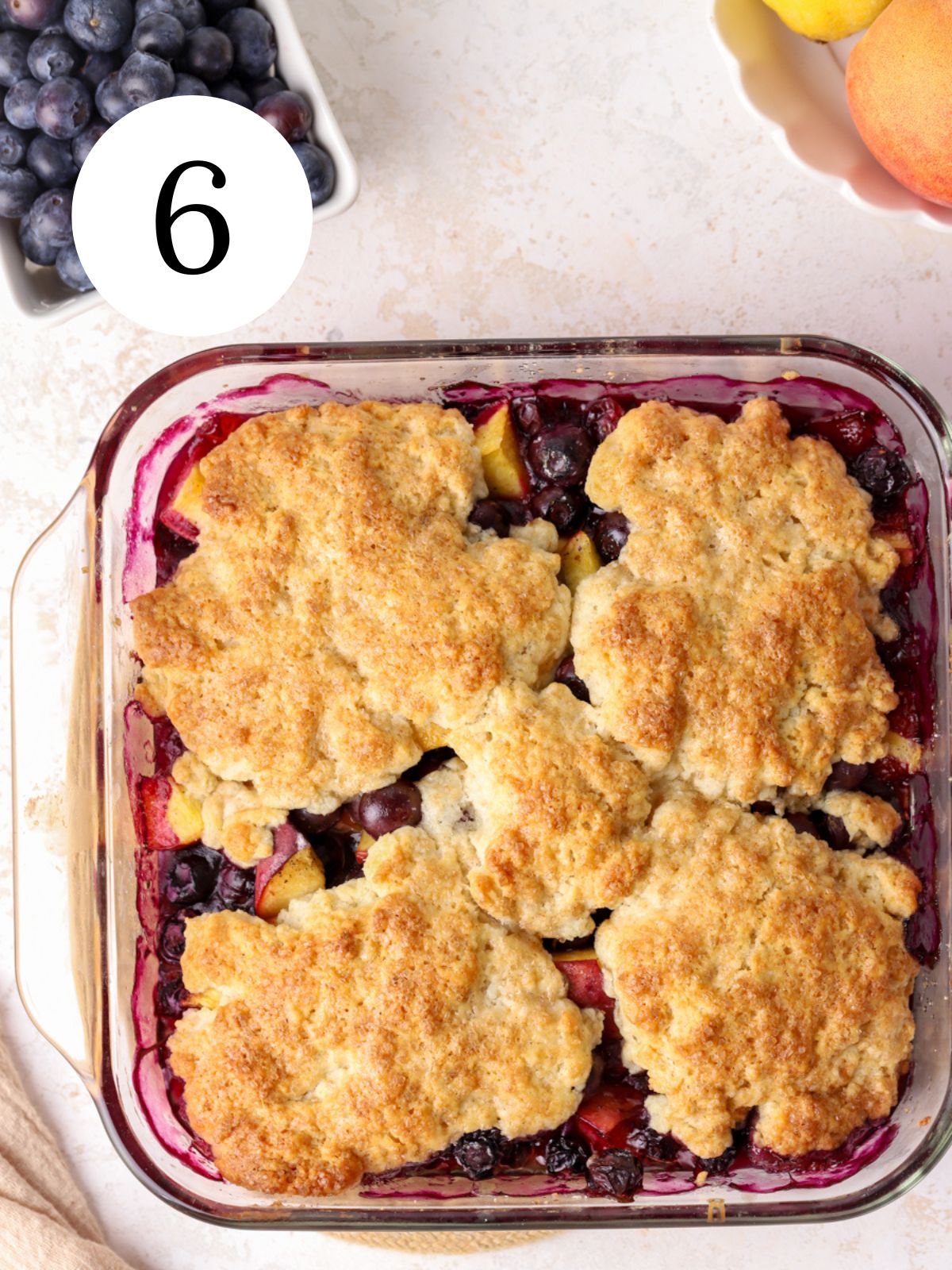 Blueberry and peach cobbler in a glass baking pan. 