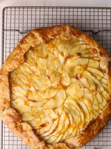 An apple tart on a cooling rack.
